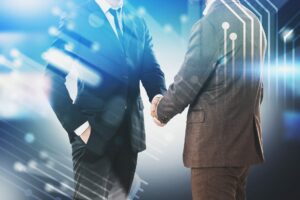 Two men shaking hands, technology concept