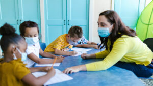 Teacher and kids in classroom with masks