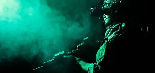 Soldier at night with green cloud and night vision goggles