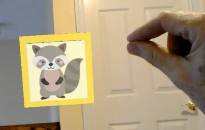 AR cartoon character over real room visual with pinched hand hovering nearby