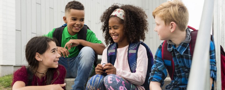 kids-on-steps-smiling-at-each-other