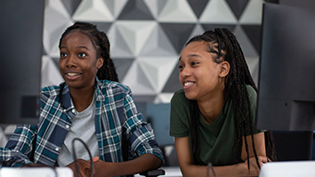 Two students in a computer lab