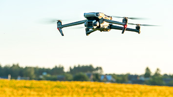 A drone hovering above a field
