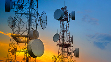 Telecom towers at sunset