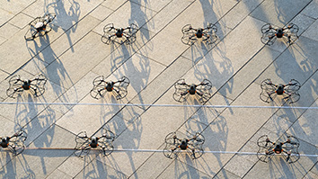 Small drones staged on a cement surface