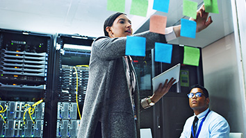 Two IT professionals solving a problem