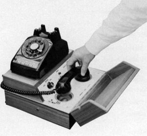 acoustic-modem rotary phone on box with holder for handset